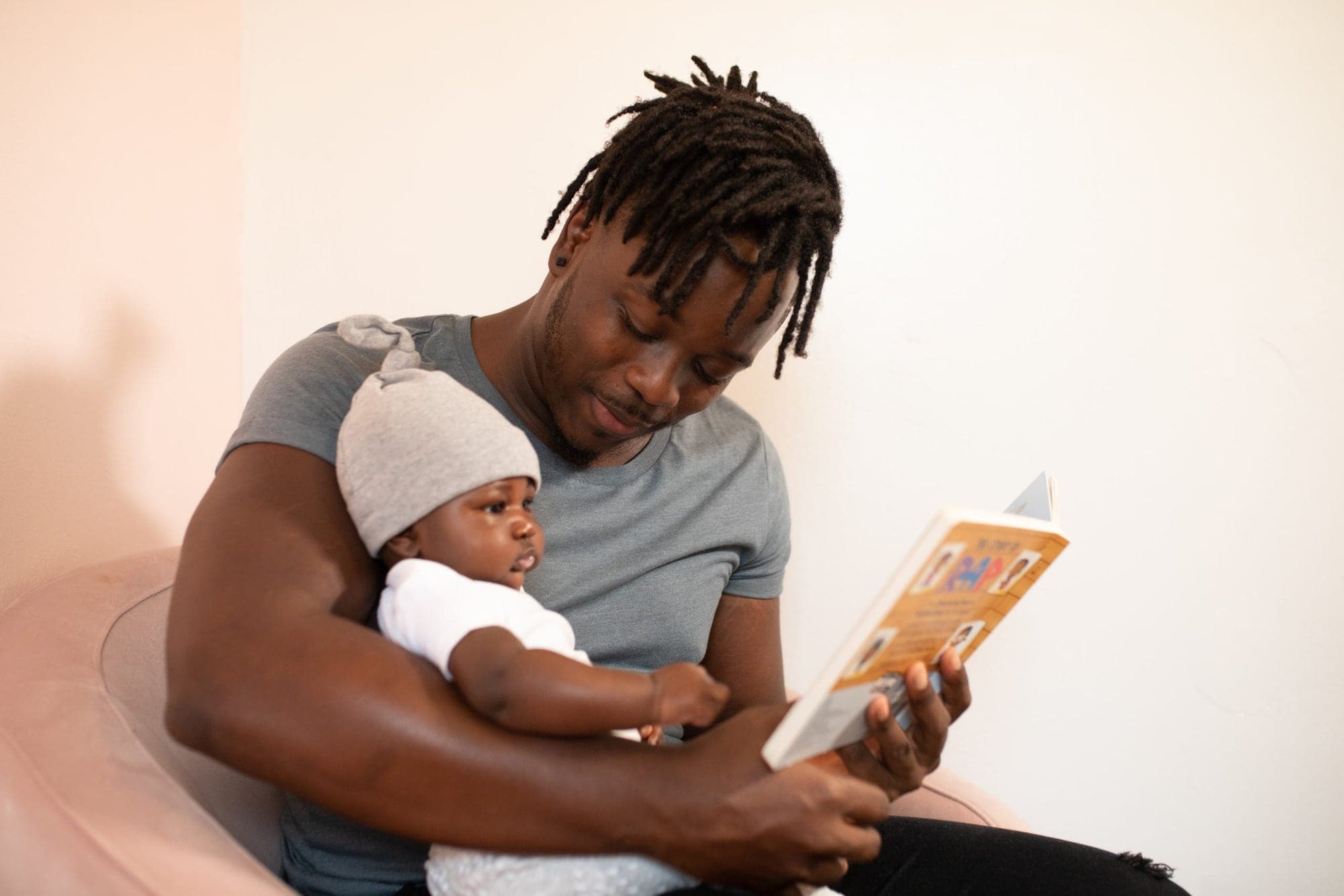 A father reading a picture book to his baby