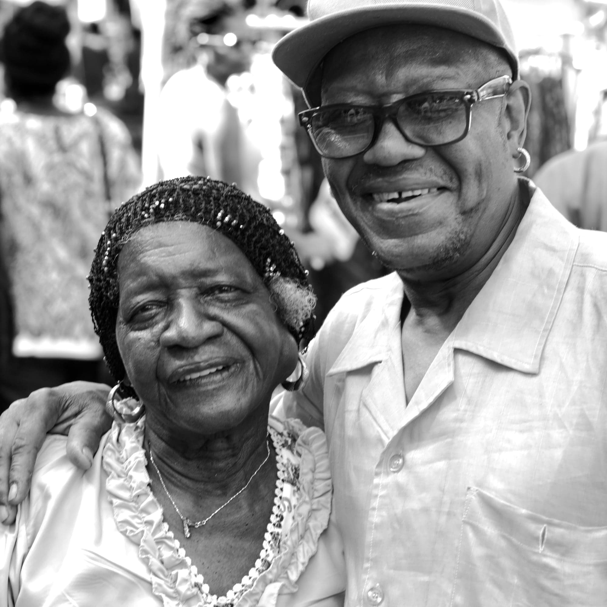 Grandparents smiling side by side, in black and white